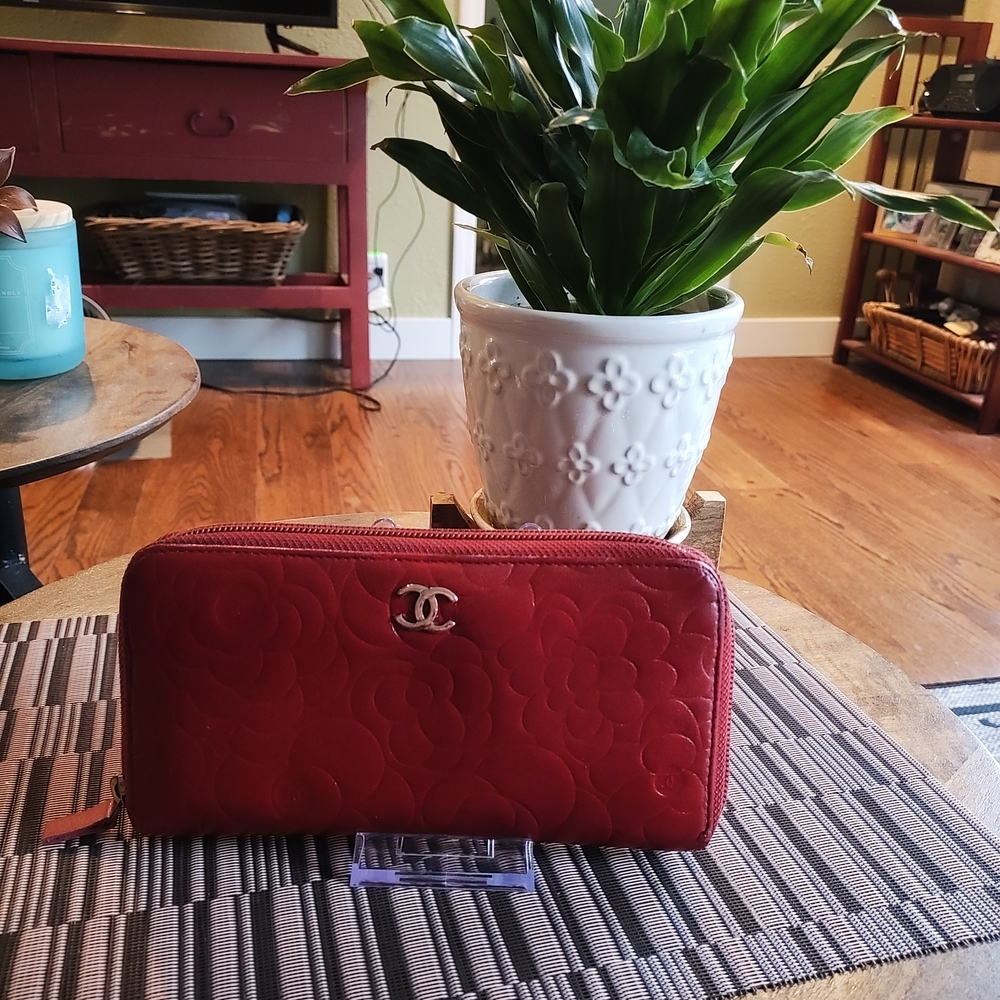 Authentic Chanel Red Camellia Leather Wallet With Iconic Logo And Floral Design.